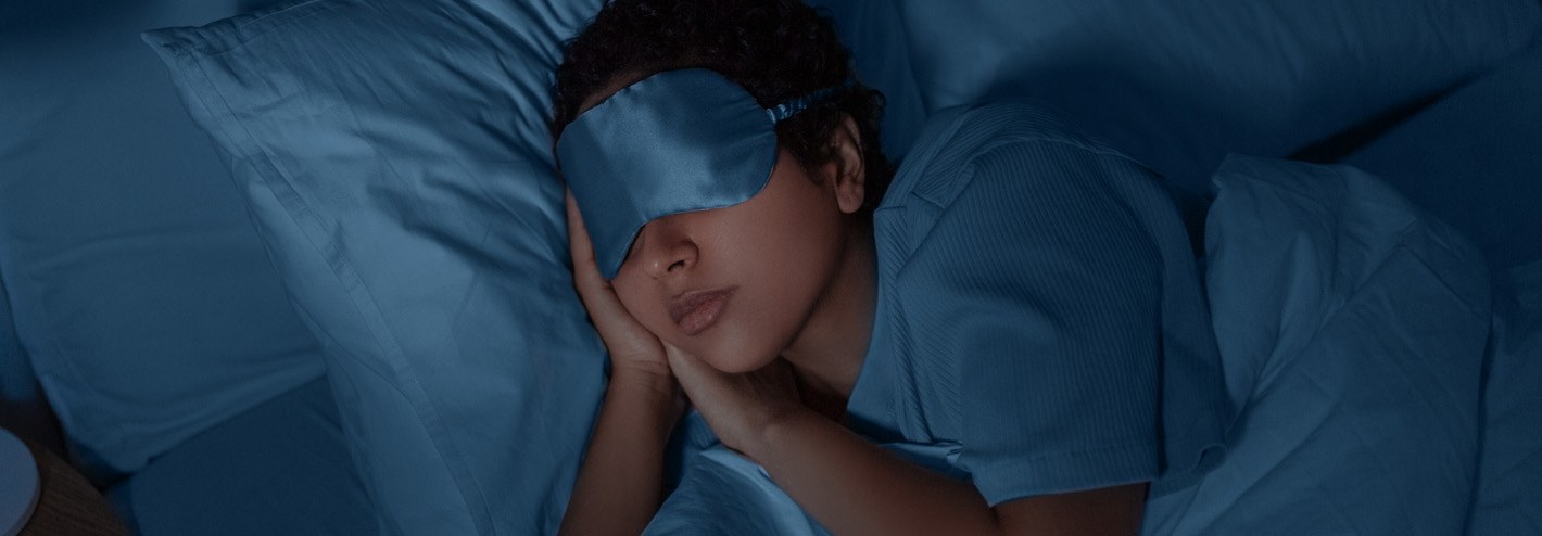 Woman asleep with eye mask